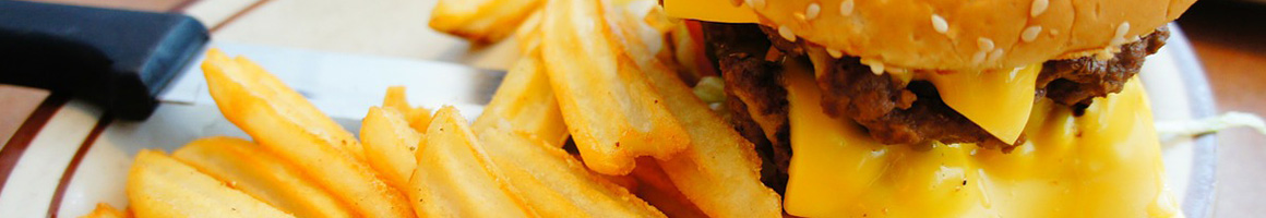 Eating American (Traditional) Burger at Baker's Drive-In restaurant in McKinney, TX.